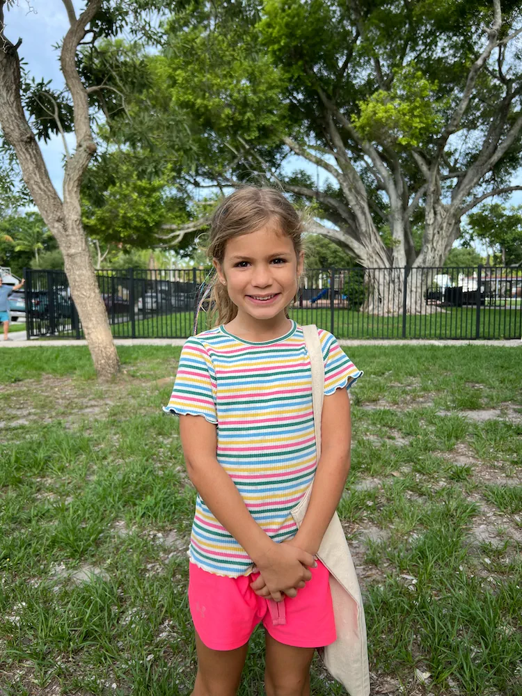 One of the kids grinning under the big shade trees at a Lee County park.